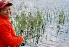 Author's son fishing for bass with a spinning reel