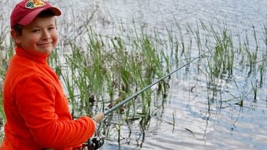 Author's son fishing for bass with a spinning reel