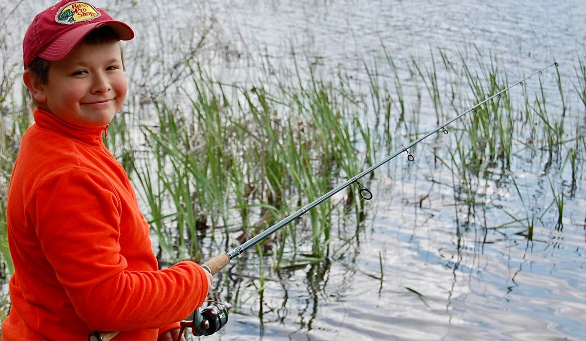 Author's son fishing for bass with a spinning reel