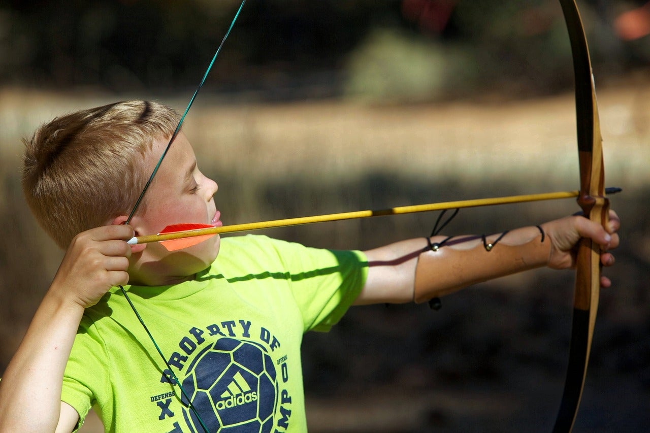 Boy shooting bow