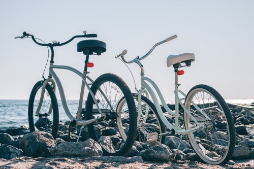 Two city bikes on the beach in the morning