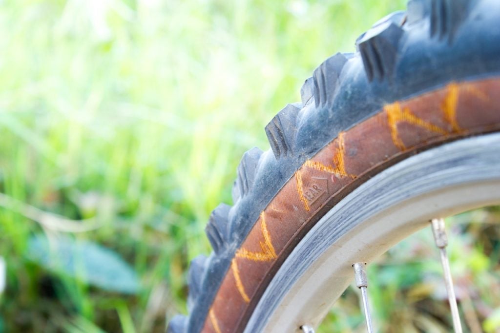 When to replace worn out mountain bike tires with sidewall damage. 